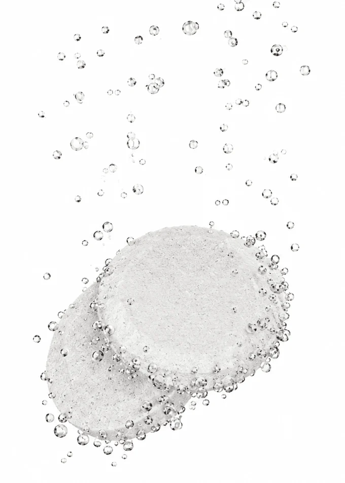 Two VitalFactors tablets fizzing in water