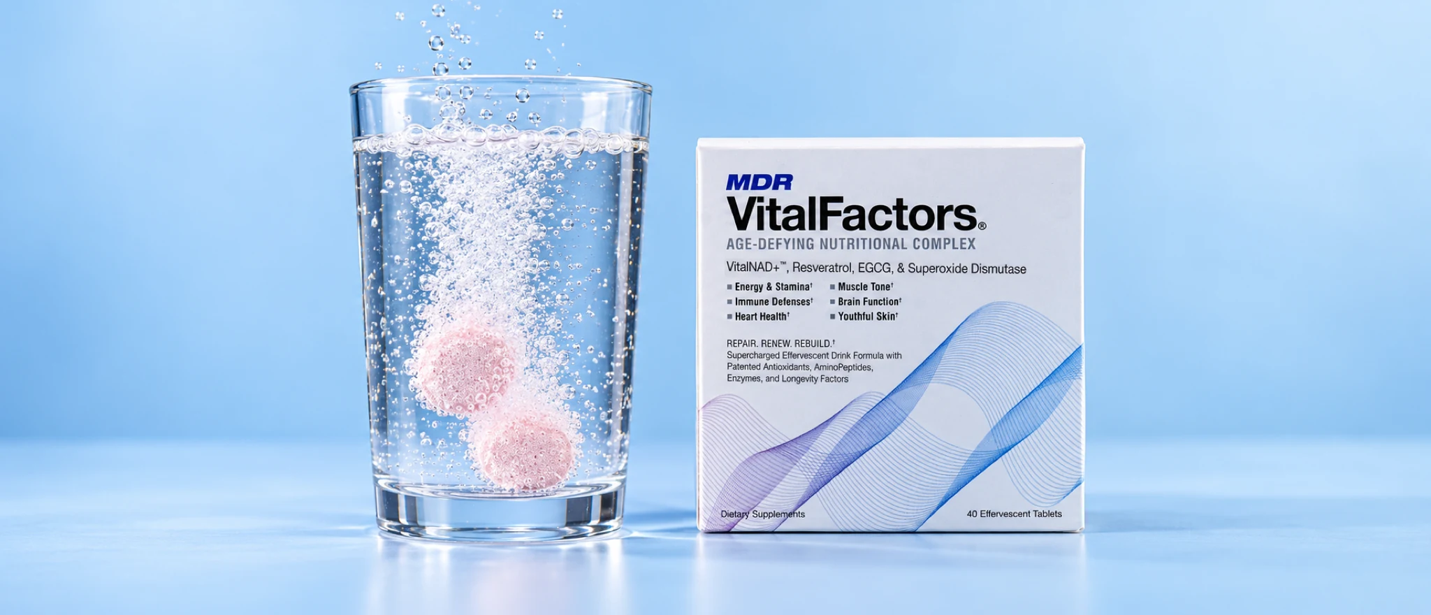 Two pink VitalFactors tablets fizzing in a glass of water next to the VitalFactors box