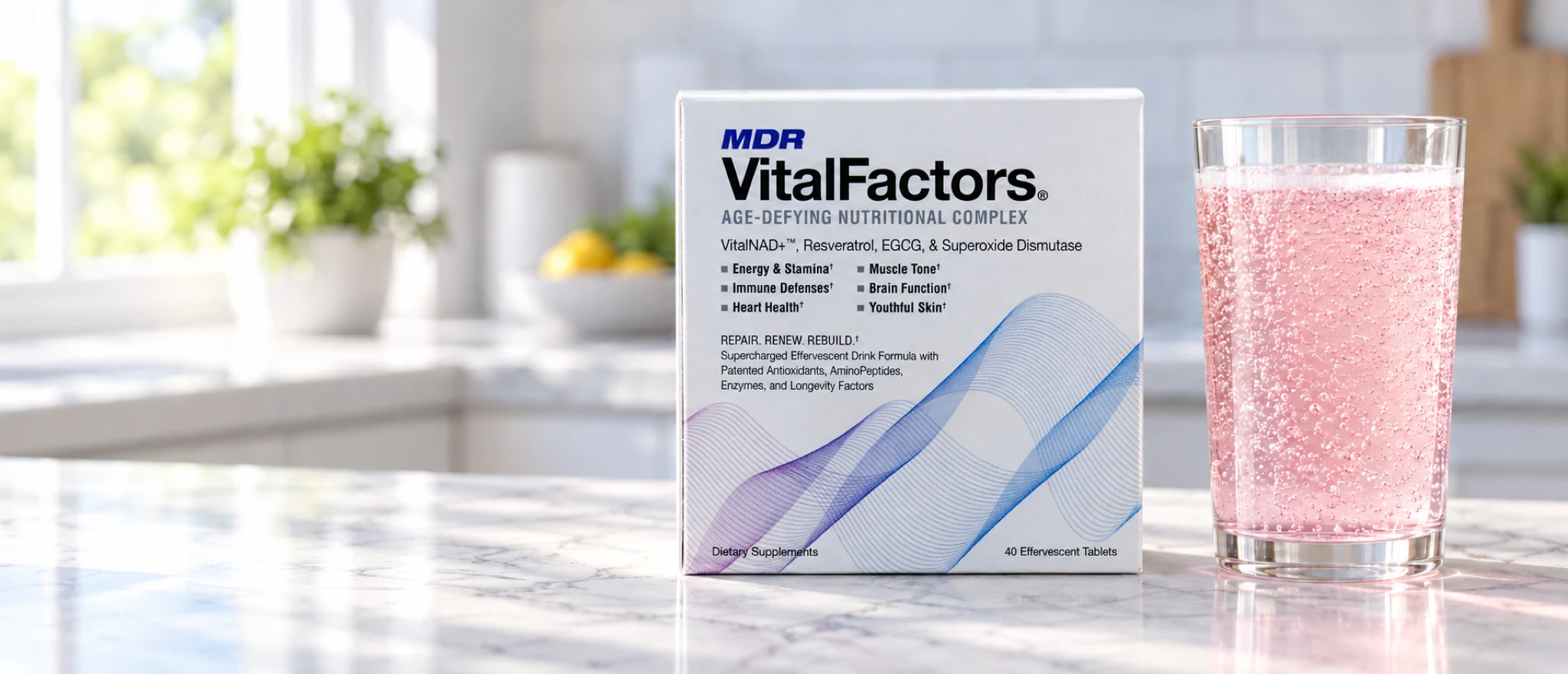 The VitalFactors box on a sunny kitchen counter next to a glass of the sparkling pink drink